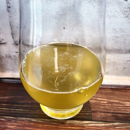 「神奈川県農協茶業センター 足柄茶の緑茶(抹茶入り)のボトル缶」をテイスティンググラスに注いだ画像