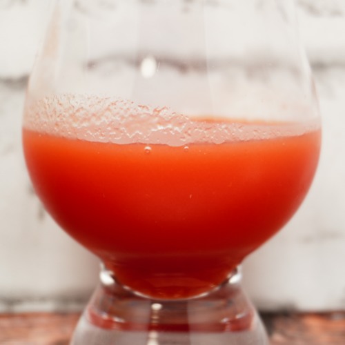 「さかえむらトマトジュース(有塩タイプ)」をテイスティンググラスに注いだ画像