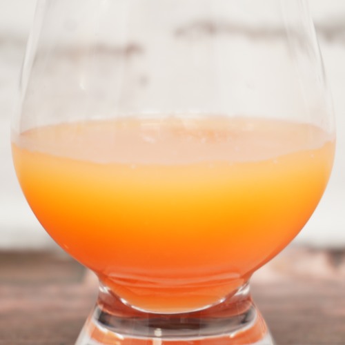 「Wow コールドプレスオーチャード ピンクグレープフルーツ果汁」をテイスティンググラスに注いだ画像